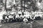 Black and white photo of men seated and standing in Waterloo Park.