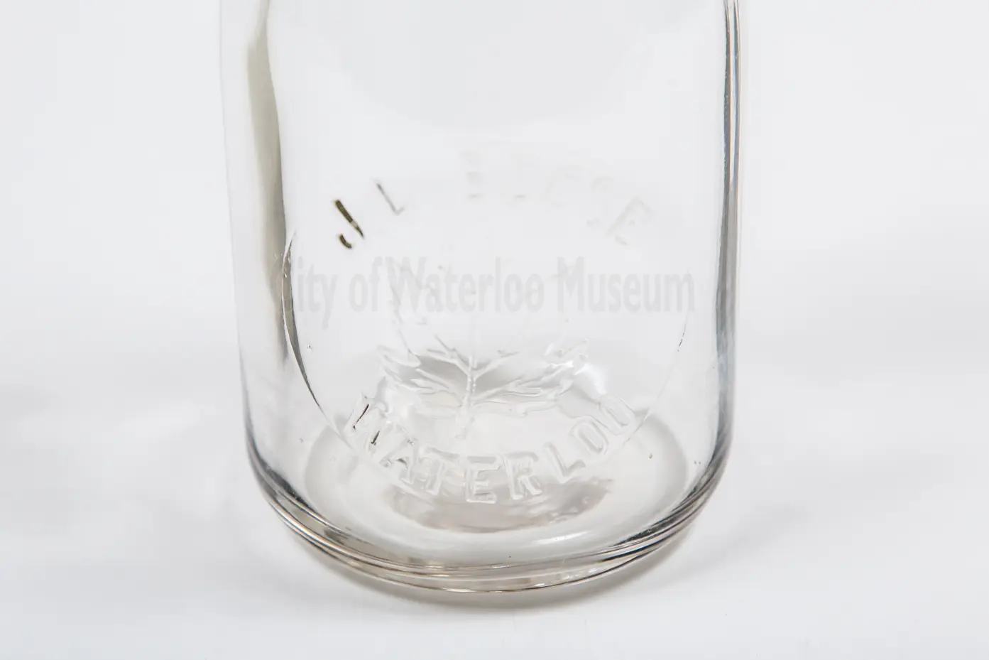 Up close view of J.L. Besse, Waterloo marking on milk bottle