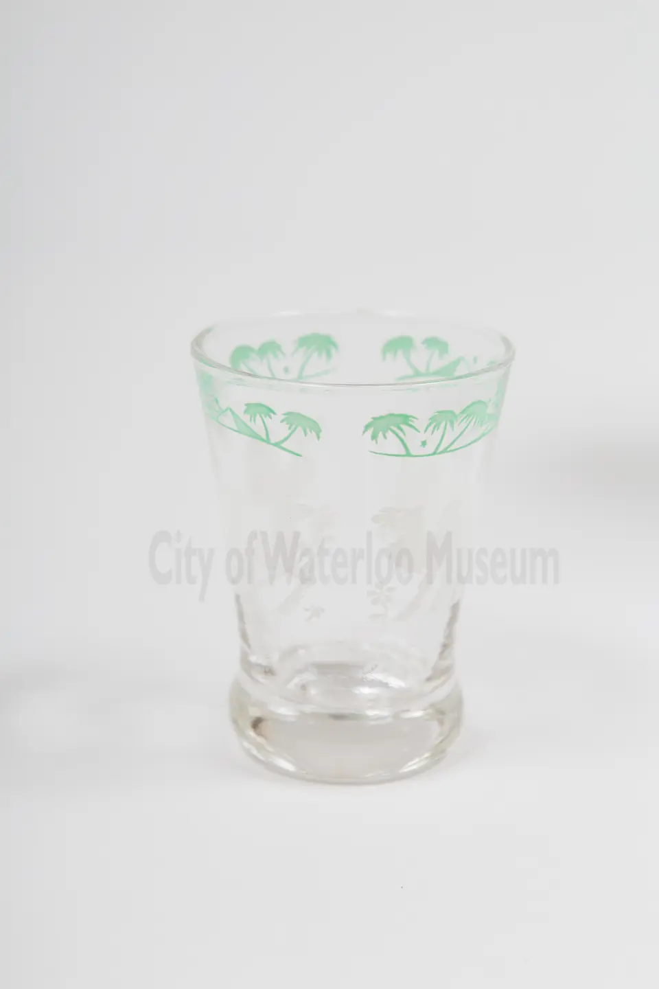 Close up of cocktail glass with palm tree and camel design
