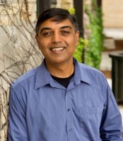 Headshot of Sanjay Govindaraj outside wearing a blue button up shirt