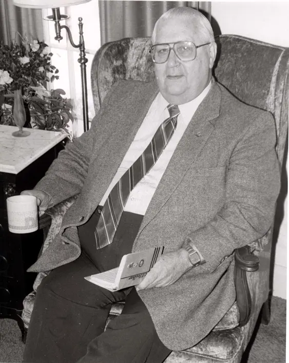 black and white photo of older man with glasses