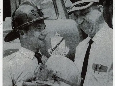 Grant Bettke shows Chief John Staller the new yellow helmets 