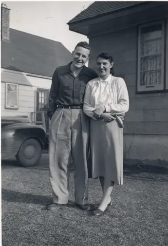 Image of couple in front of house