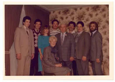 Image of formally dressed family of nine