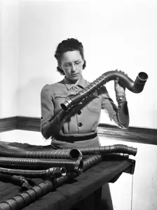 Image of woman inspecting piping