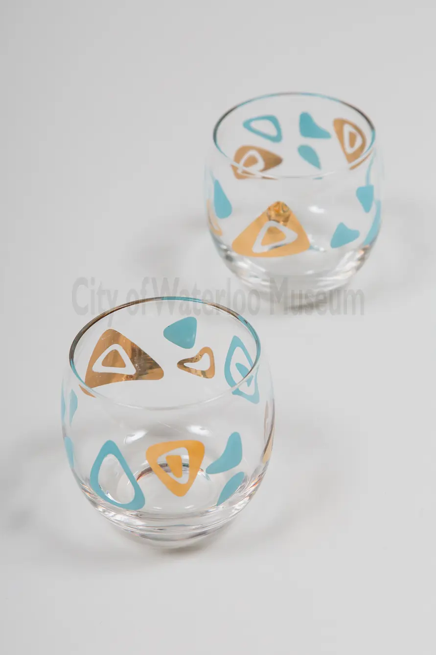 Close up of two glasses with teal and gold amoeba pattern