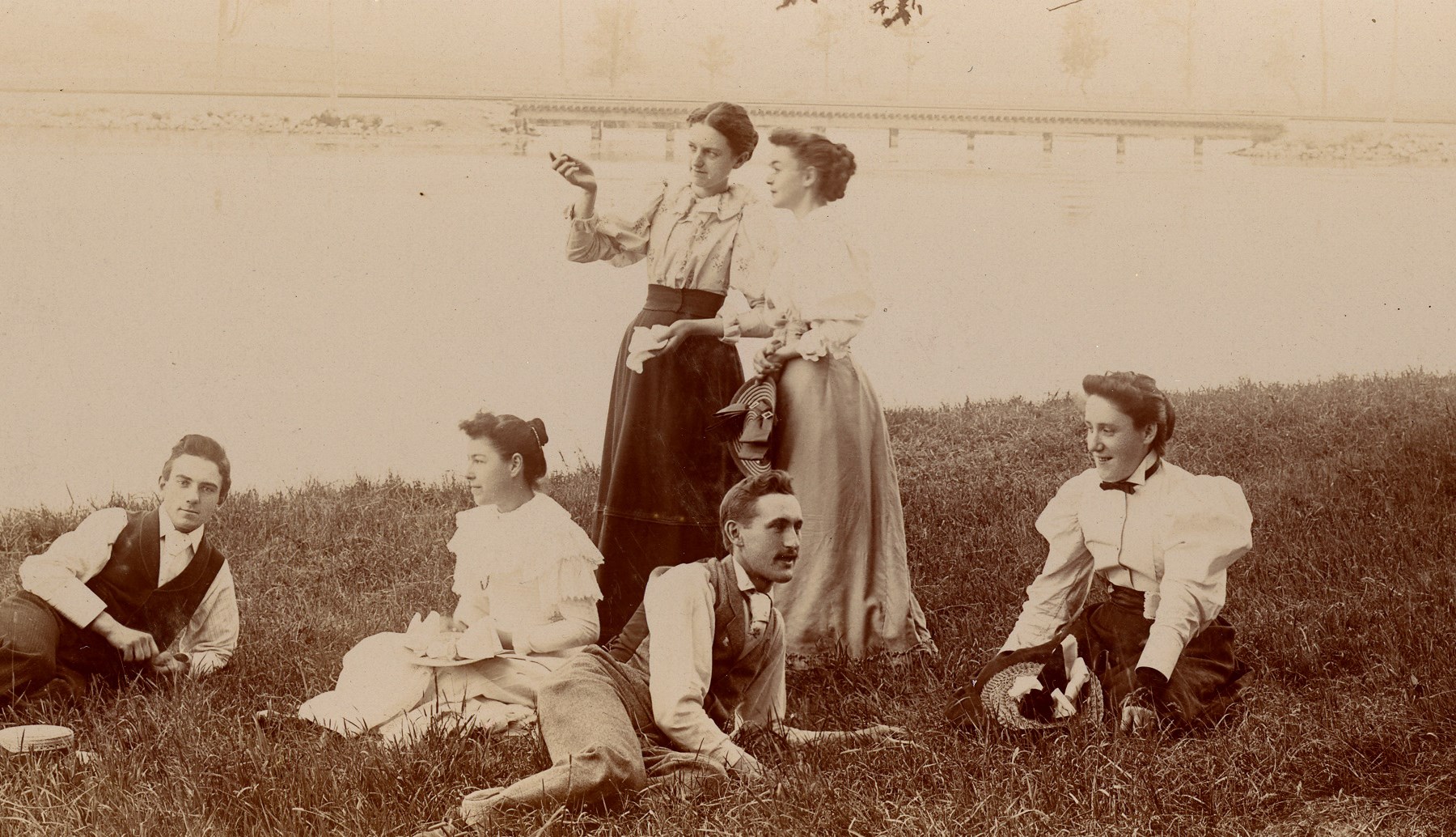 Sepia-toned 1894 photograph of a small group picnic at the lookout point overlooking Silver Lake in Waterloo Park, with tree canopy and lake visible.