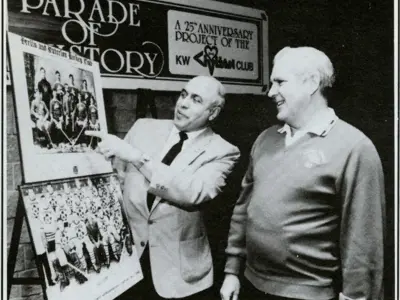 Mayor Don Cardillo (left) and Ed Davies (right) viewing plaques of history hockey teams from K-W.