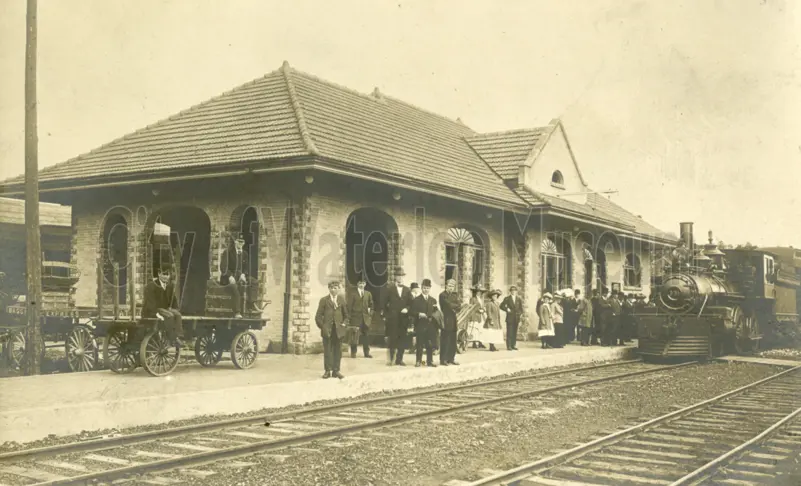 Image of Waterloo Train station printed on a postcard in black and white sepia tones