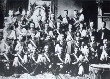 Black and white photo of Waterloo band seated and standing in rows. Kaufman, in uniform holding a tuba, is at the top left.