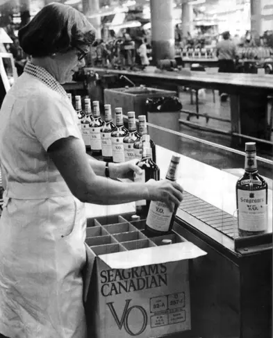 Image of woman packing a crate of bottles