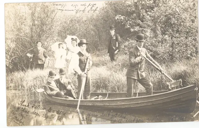 Vintage photo of people in rowboats on Silver Lake, some wearing wide-brimmed hats, with calm water reflecting trees and park shore.