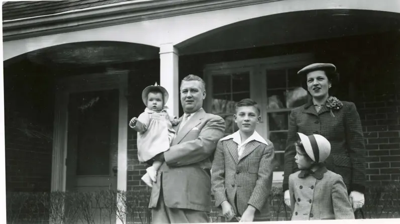 Charlie's family outside the door step of his house