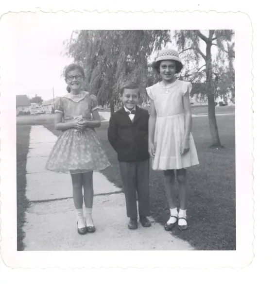 Image of three children on sidewalk