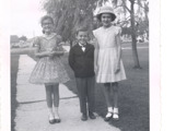 Image of three children on sidewalk