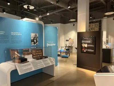 Photo of the Cipher Decipher exhibit with text panels and artifacts on display