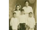 Black and white photo of mother Anna and 4 kids standing