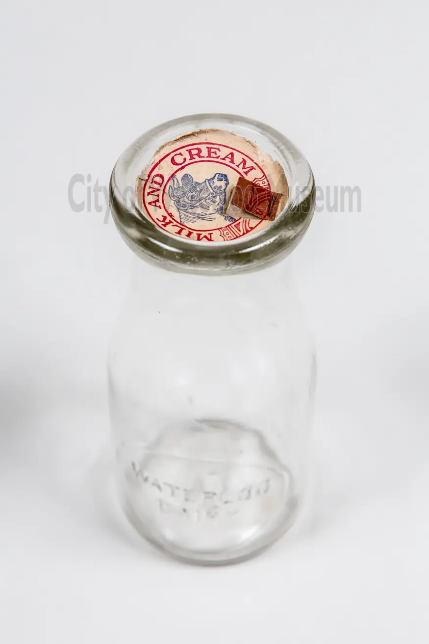 Image shows a milk bottle for cream from the top down. 