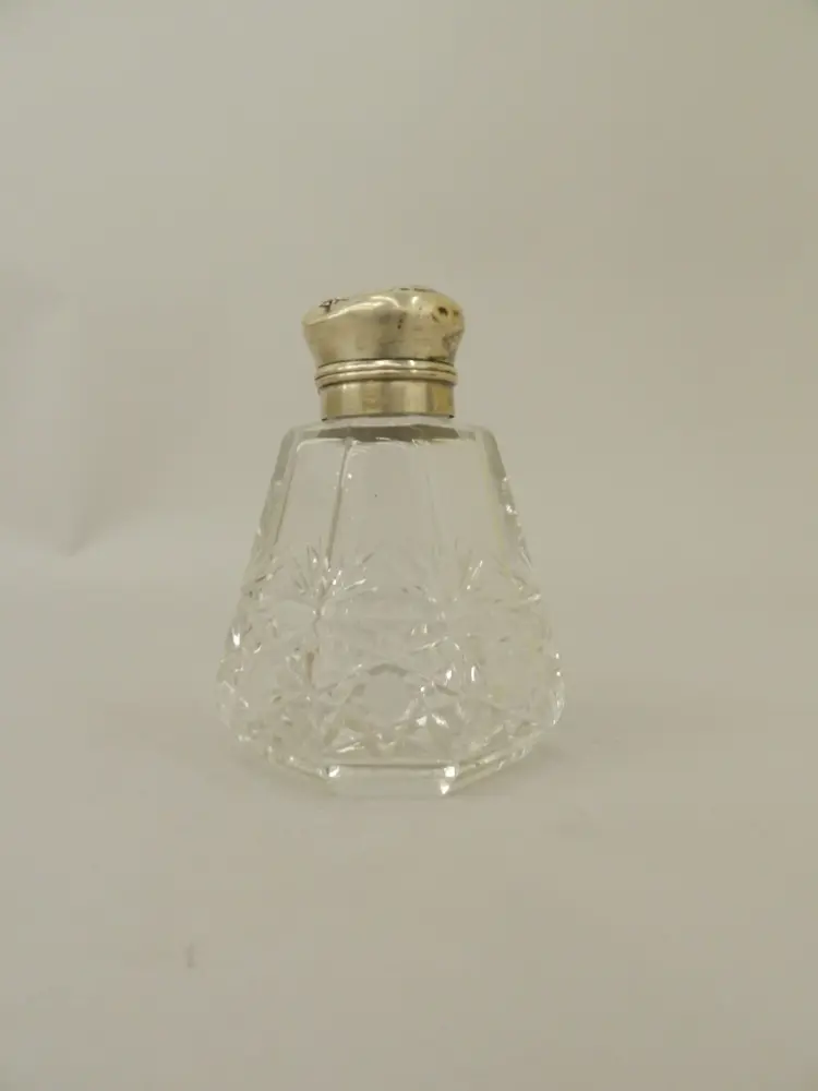 Image of empty triangular perfume bottle