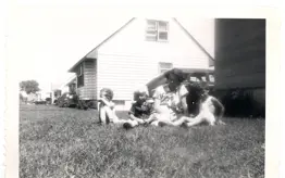 Image of children and mother on lawn