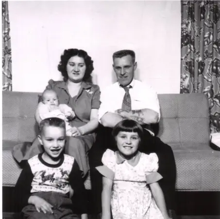 Image of two parents with three children