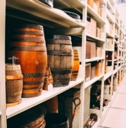 Image shows barrels stacked on a shelf