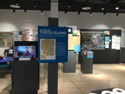 Photo of exhibit space with maps on display