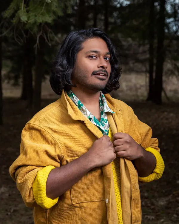 Portrait of individual with yellow jacket. 