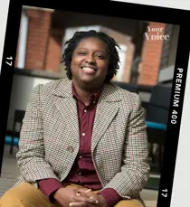 Photograph of person sitting in suit-jacket