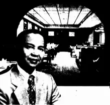 Image of man in front of restaurant interior