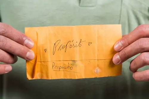Photograph of hands holding a brown envelope
