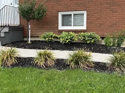Diagram showing a ground slope rising away from a house foundation so that water drains outward from the building.