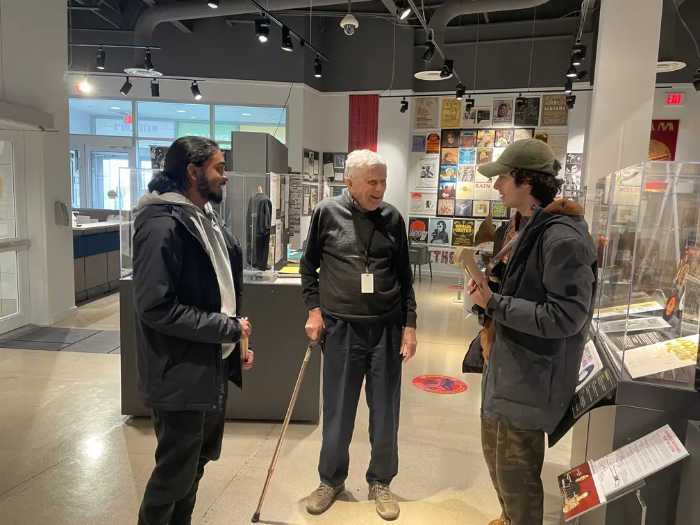 Blind man volunteering with museum goers