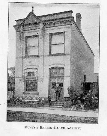 Man standing before brick building