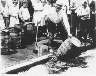 Men emptying whisky barrels