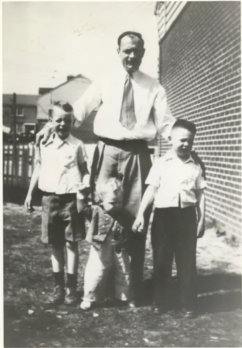 Image of three children with father