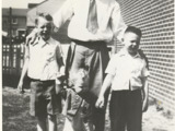 Image of three children with father